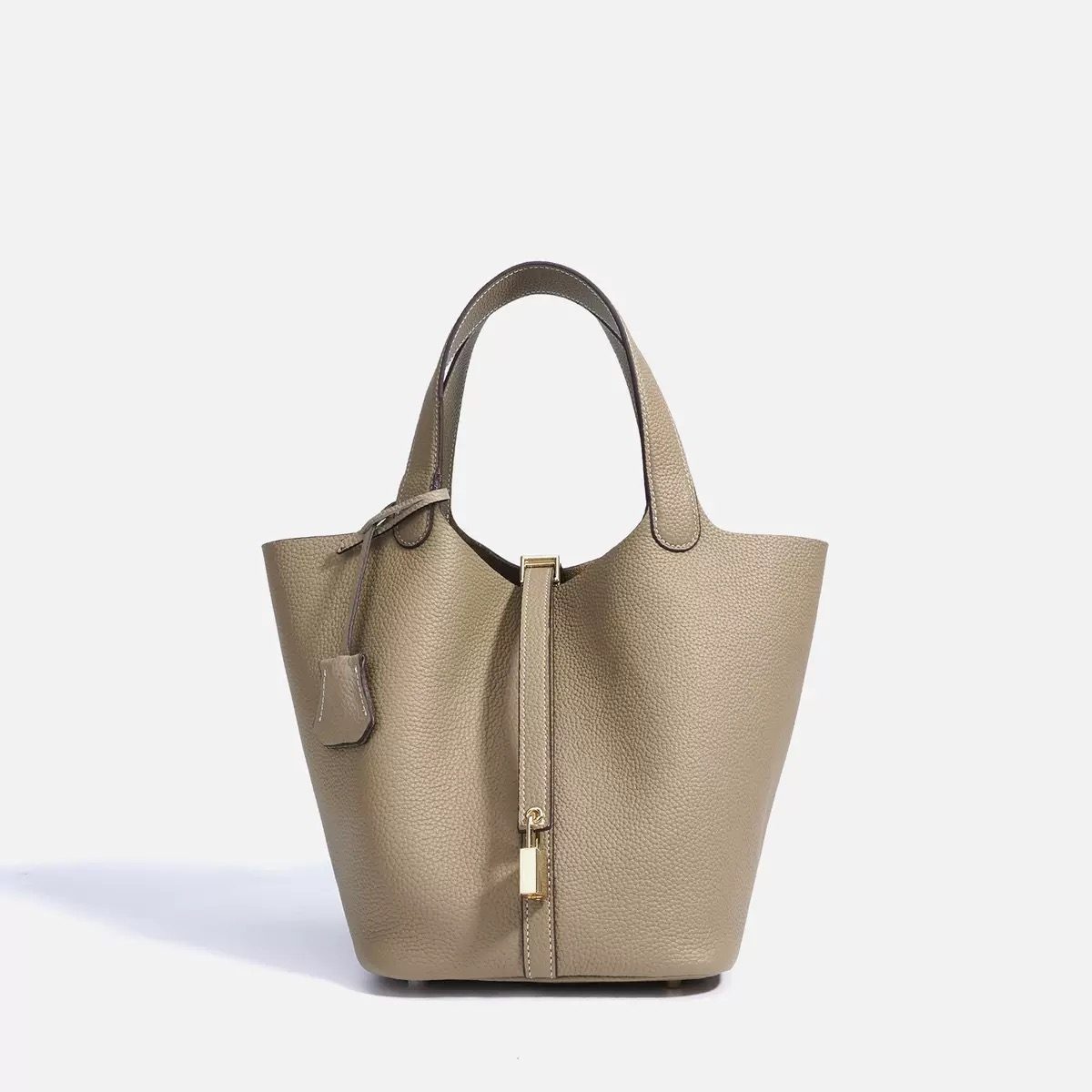Sustainable leather bags displayed with natural materials in an eco-friendly setting