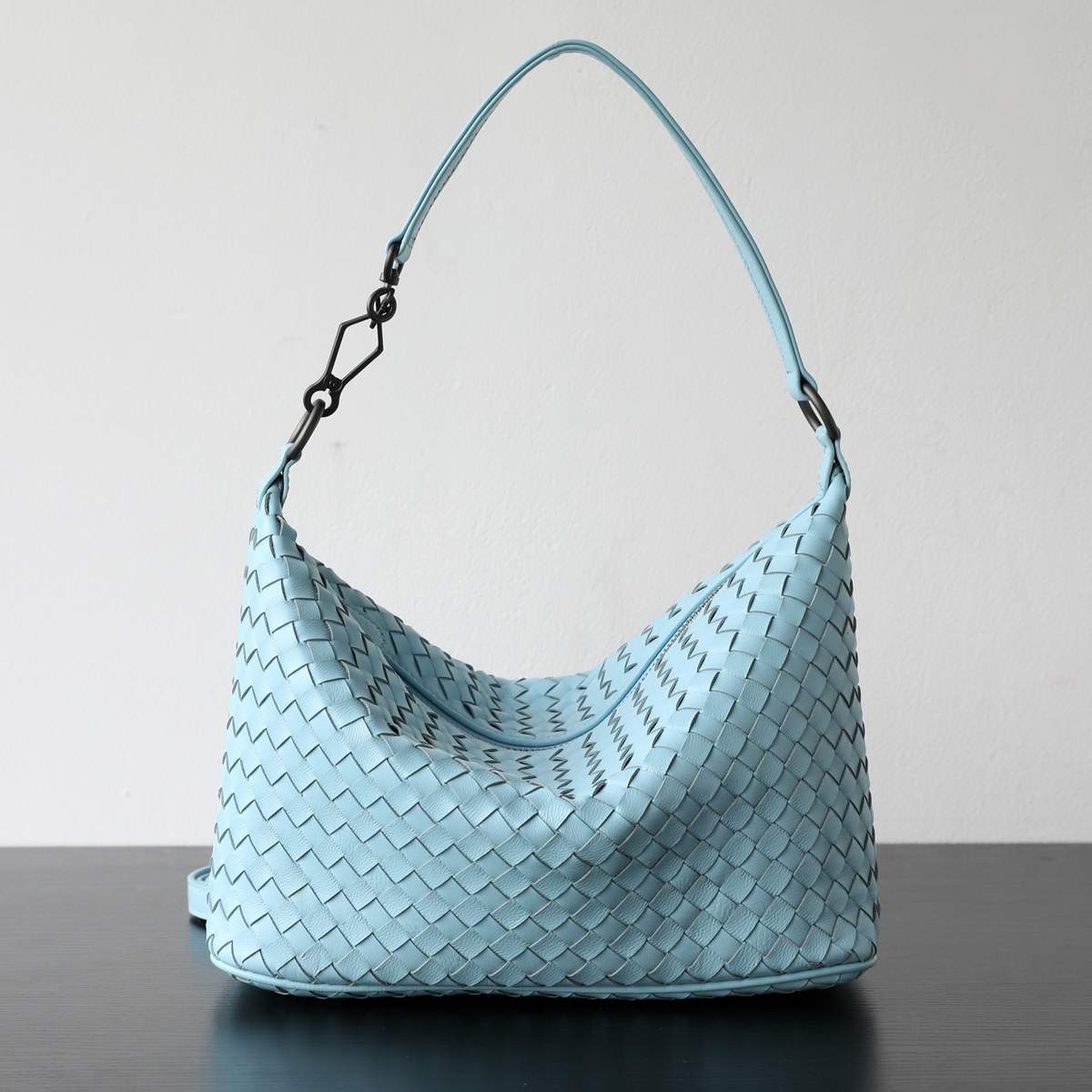 Sheepskin Dumpling Bag in Beige — worn on shoulder